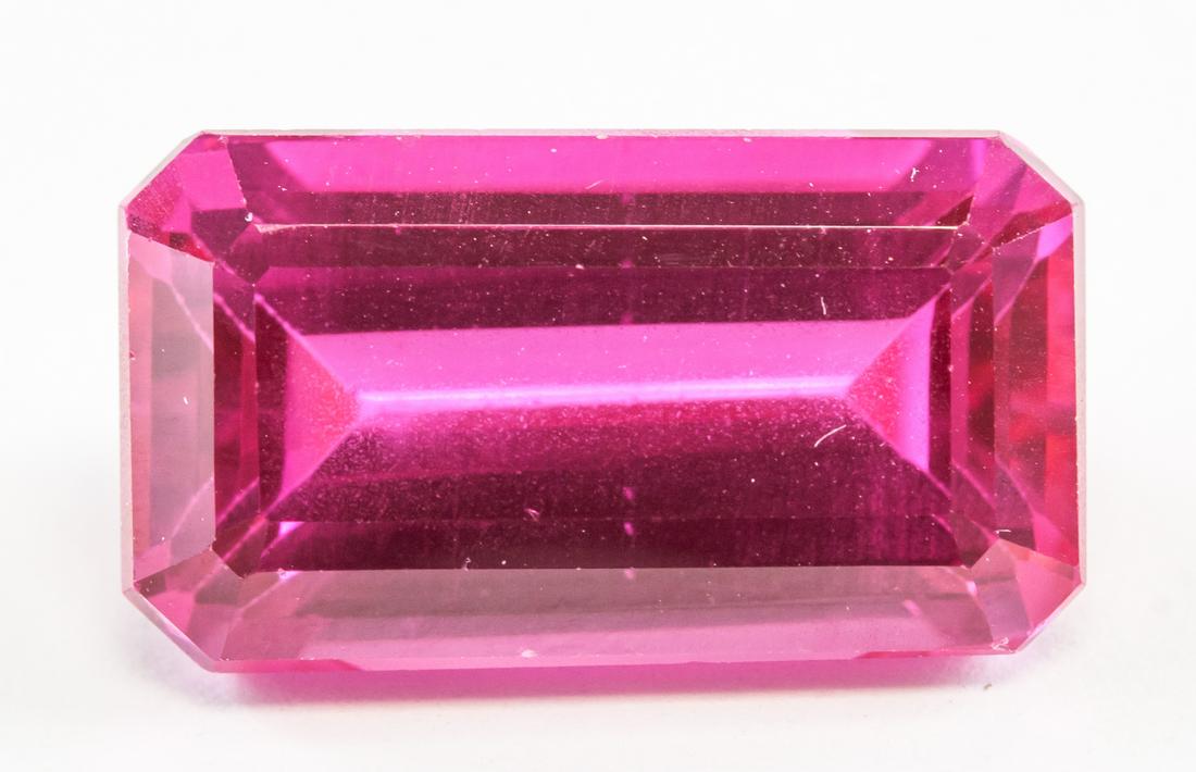 18.25ct Emerald Cut Pink Natural Danburite GGL: One (1) 18.25 ct emerald cut pink natural danburite. Origin: Mexico. Accompanied with GGL certificate. 18.60 x 10.30 x 8.10 mm.