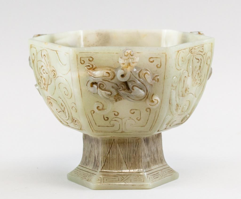 Chinese Green Jade Dragon Hexagonal Stem Cup: Chinese jade carved hexagonal stem cup. Green translucent tone with mutton fat suffusions. Each side carved in relief with chilong and Buddhist Daoist symbols framed within Taotie like designs. Restin