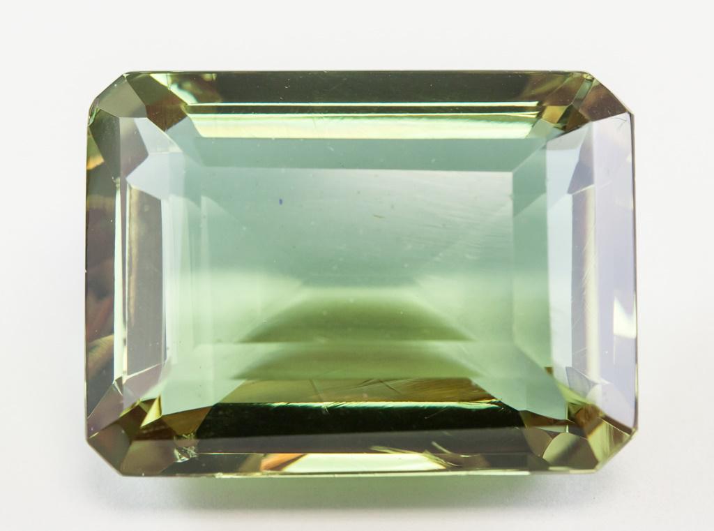 81.70ct Emerald Cut Brown to Green Alexandrite GGL: One (1) 81.70 ct emerald cut brown to green alexandrite. Origin: Brazil. Accompanied with GGL certificate. 29.43 x 22.09 x 15.03 mm.