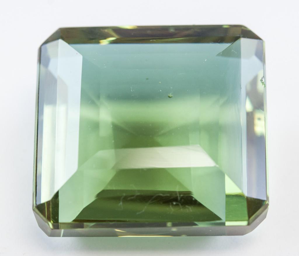 88.70ct Emerald Cut Brown to Green Alexandrite GGL: One (1) 88.70 ct emerald cut brown to green alexandrite. Origin: Brazil. Accompanied with GGL certificate. 29.48 x 25.32 x 14.72 mm.