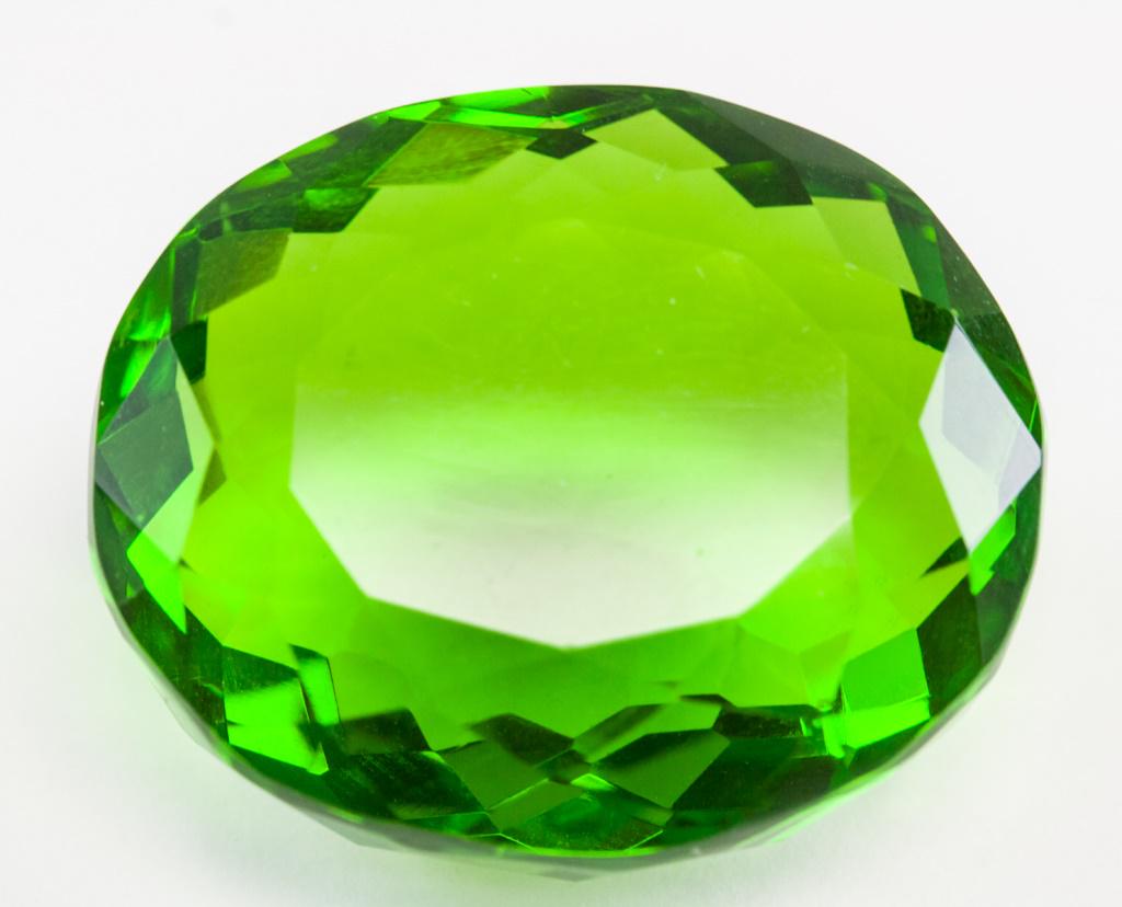 69.25ct Oval Cut Green Peridot GGL Certificate: One (1) 69.25 ct oval cut green peridot. Origin: Brazil. Accompanied with GGL certificate. 29.10 x 24.50 x 14.80 mm.