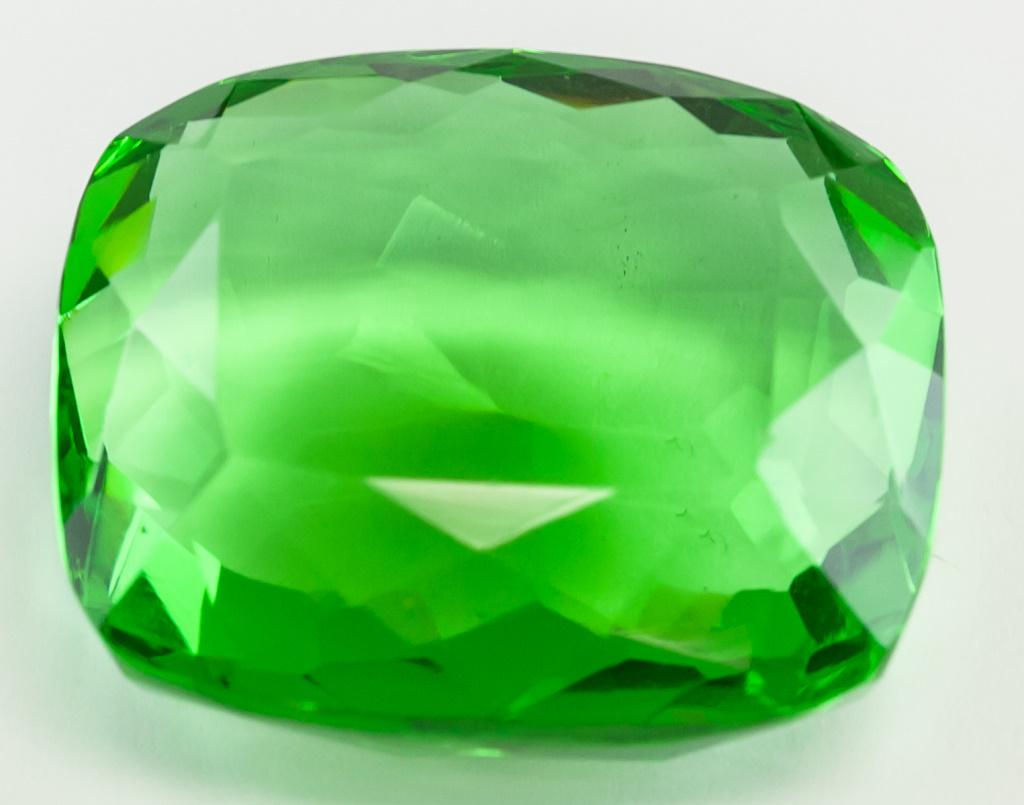 86.55ct Cushion Cut Green Peridot GGL: One (1) 86.55 ct cushion cut green "PERIDOT". Origin: Brazil. Accompanied with a GGL certificate. 30.30 x 26.29 x 14.36 mm
