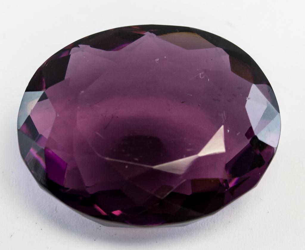 76.80ct Oval Cut Brown Purple Alexandrite GGL: 76.80 ct oval cut brown to purple "ALEXANDRITE". Origin: Brazil. Accompanied with a GGL certificate. 32.01 x 26.26 x 13.93 mm