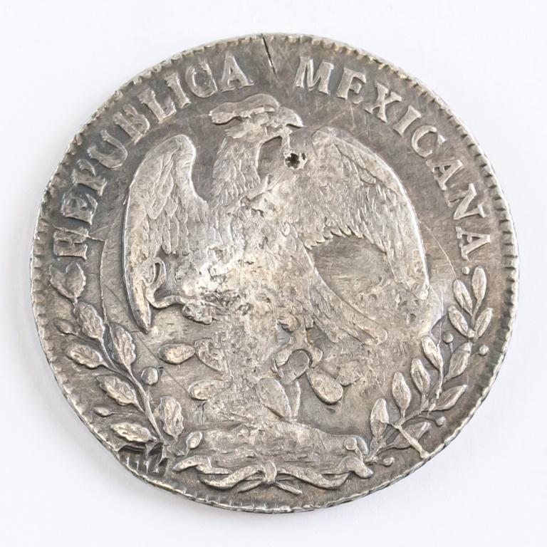 Mexican 8 Reales 1883 Coin: Mexican coin. Obverse: Eagle with snake on cactus. REPUBLICANA MEXICANA. Reverse: Radiant cap with rays. 8R. C. 1883 M. M. 10Ds. 20Gs. With numerous chop marks on obverse and reverse. Diameter: 4 cm. 