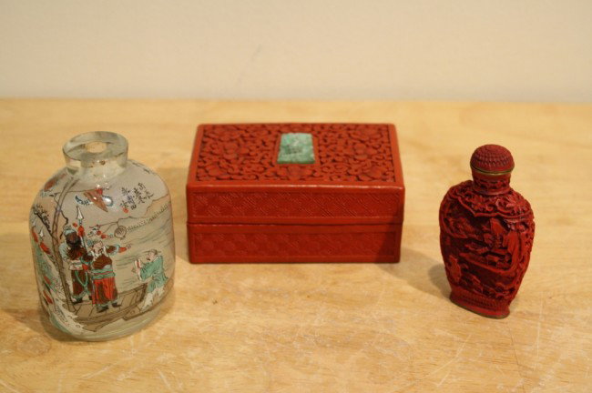 Two snuff bottles and one cinnabar box: One jade snuff bottle, one cinnabar snuff bottle and a cinnabar box with jade ornament on the lid. Various sizes.