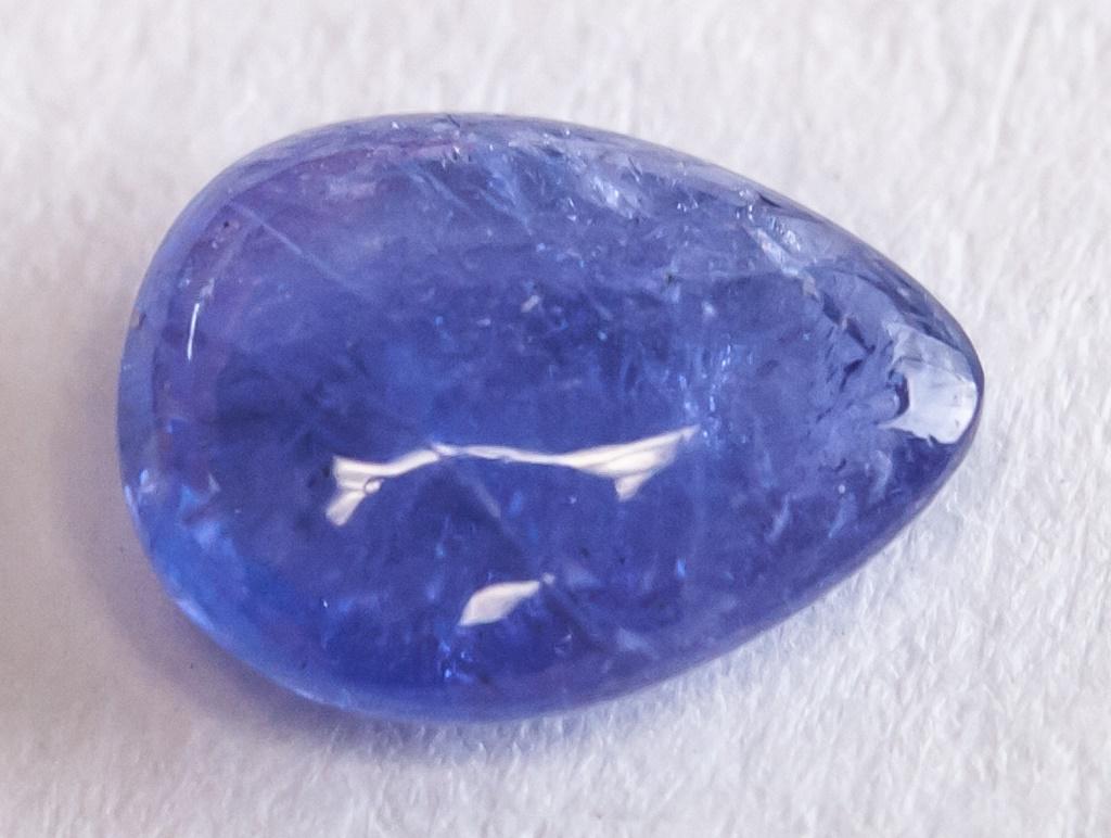 1.35ct Pear Cut Blue Natural Tanzanite: 1.35 ct pear cabochon blue natural tanzanite. Accompanied with GLI certificate. 8.15 x 6.25 x 2.95 mm.