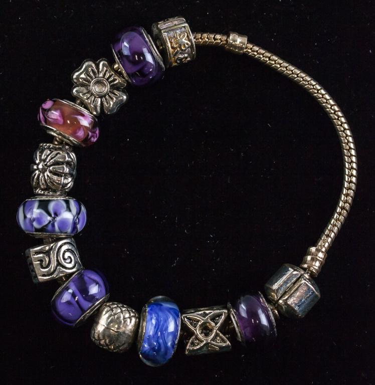 Silver Bracelet with Blue and Purple Charms: Silver bracelet with pandora-like charms and spacers. Of purple and blue tones. Bracelet carries 925 stamp. 7 cm. 40 grams. Silver not tested for purity.