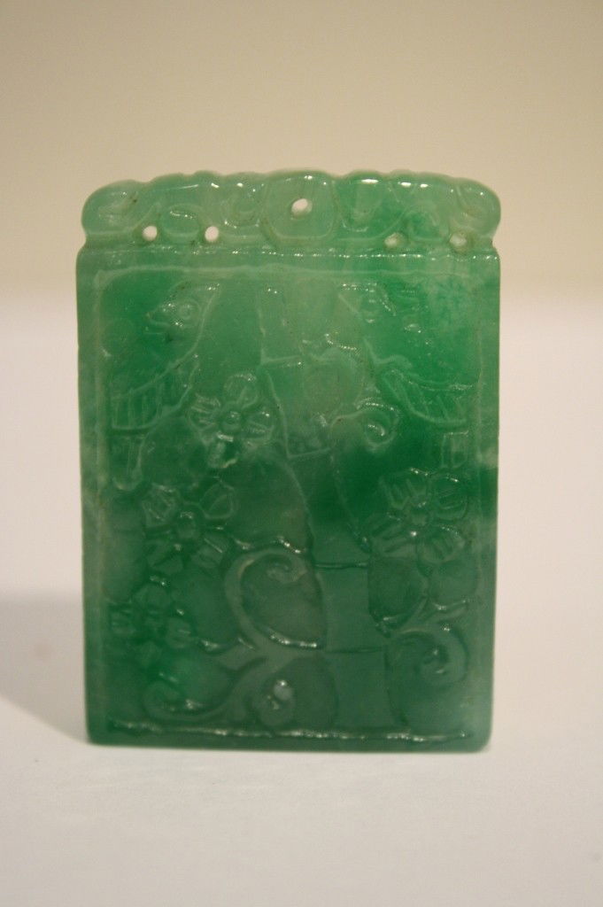 a chinese carved jadeite pendant, engraved with flo: a chinese carved jadeite pendant, engraved with floral, 1 3/4 X 1 1/4