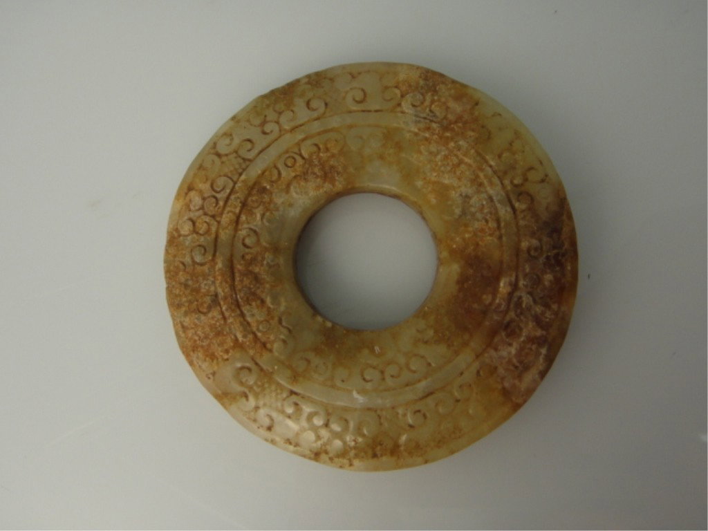 17th/18th C. White Jade Ritualistic Bi Disc: CHINESE WHITE JADE RITUALISTIC BI DISC Chinese carved jade bi ritualistic disc; finely carved designs; of light brown suffusion, 17th/18th Century 2 1/2" diameter | JADE