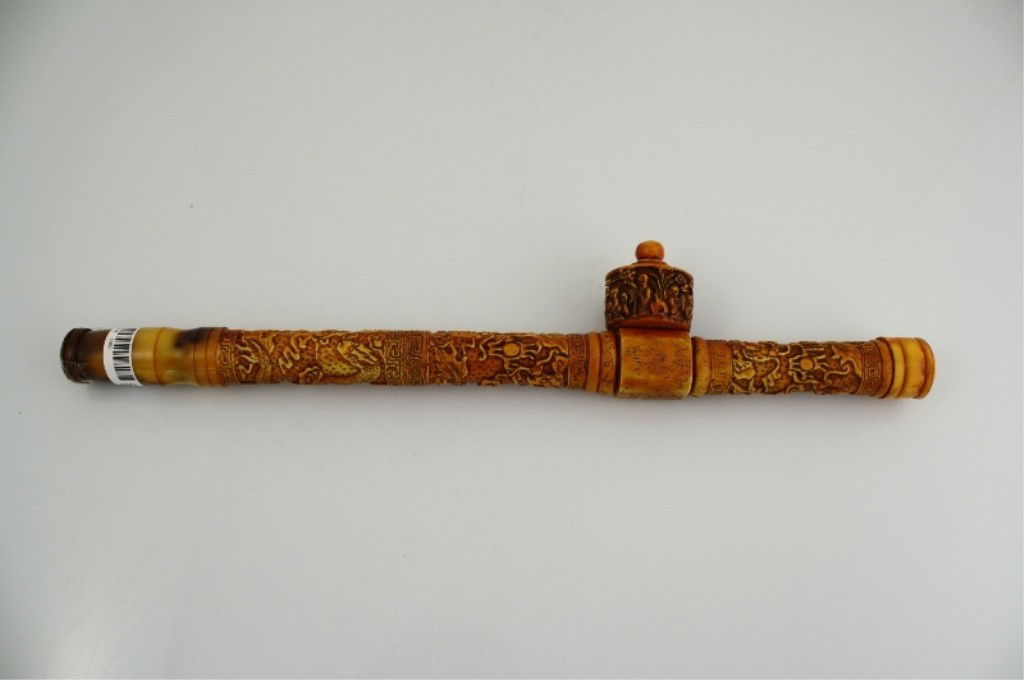 Antique Chinese Carved Opium Pipe: ANTIQUE CHINESE CARVED OPIUM PIPE Antique Chinese carved opium pipe; stem featuring carved dragons in relief Form / Medium Used: Opium Pipe Dimensions: 15" long
