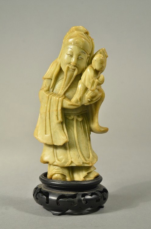 Chinese Soapstone Carving of Man with Baby: Finely carved Chinese soapstone figure of man cradling a baby; 7 1/2" tall, 2 3/4" wide