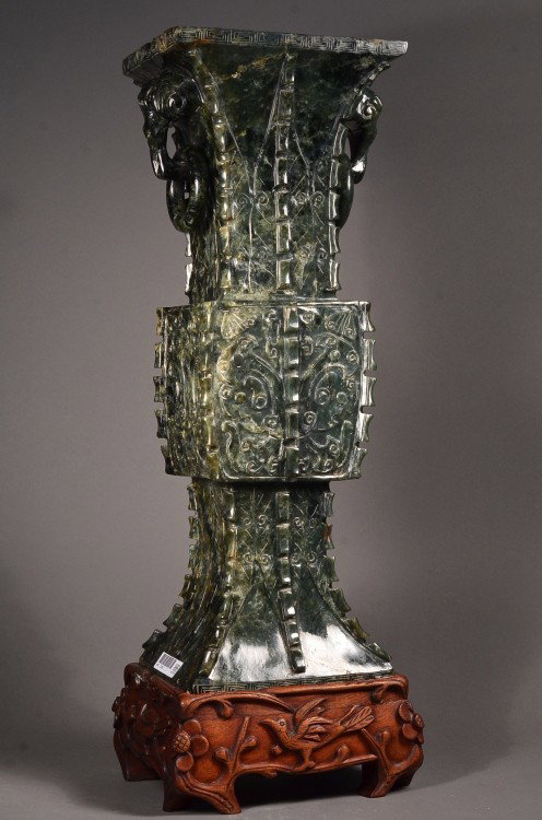 Rare Chinese Fang Zun Spinach Green Jade Gu Vase: Finely carved and rare, tall Chinese Fang Zun jade vase; gu shaped with square sectioned form with heavy raised geometric flanges to the corners of the body; each side of sectioned squared decorated w