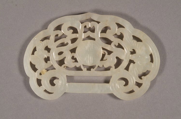 Chinese Openwork Hetian Huang Jade Shou & Bats: Chinese white Hetian jade pendant: ritualistic huang design, with incised shou longevity roundel at centre flanked by antithetical bat motif alongside foliate scrolls throughout pendant; 8.5 cm X 5 cm