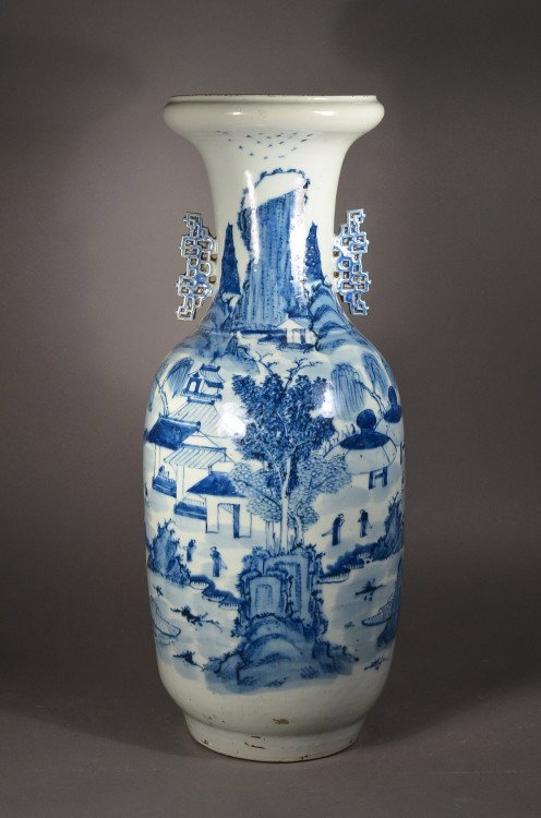 20th C. Chinese Blue & White Rouleaux Vase: Chinese porcelain rouleaux vase with openwork flanges; ovoid body featuring landscape scene tapered bottom, early 20th Century; H: 23", D: 9". Vase has a natural tilt.