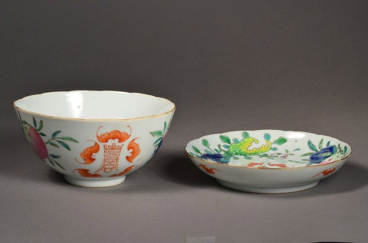 Chinese Qing Famille Rose Shou Saucer & Bowl: Chinese Qing Dynasty Famille Rose enameled porcelain saucer and bowl; the exterior with shou longevity design flanked by auspicious bats; 5 1/2" diameter (bowl); 5 3/4" diameter (saucer)