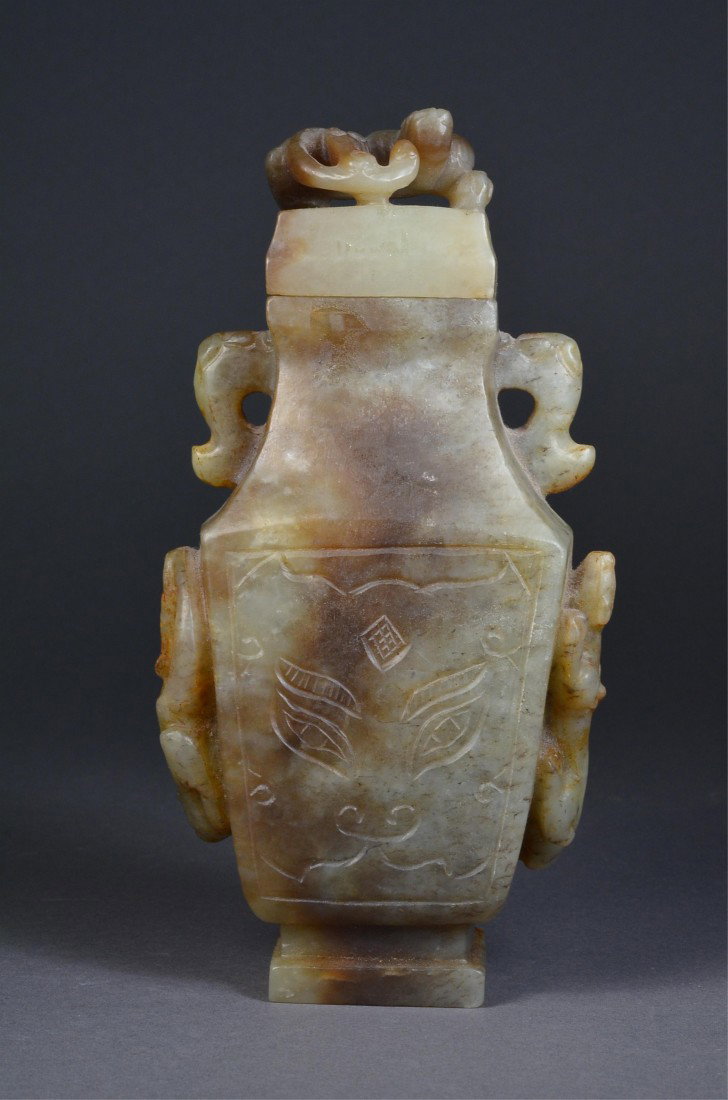 Chinese Ming Green Jade Hu Vessel Chilong: Archaistic Chinese Ming Dynasty jade vessel; hu-shaped with square body featuring taotie-like xenomorphic faces in shallow relief; handles in form of elephant heads; carved chilong dragons in relief o