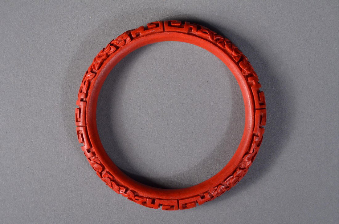 Chinese Cinnabar Lacquer Carved Bangle Lotus: Chinese cinnabar lacquer bangle: featuring carved lotus scroll alongside meander; D: 8 cm