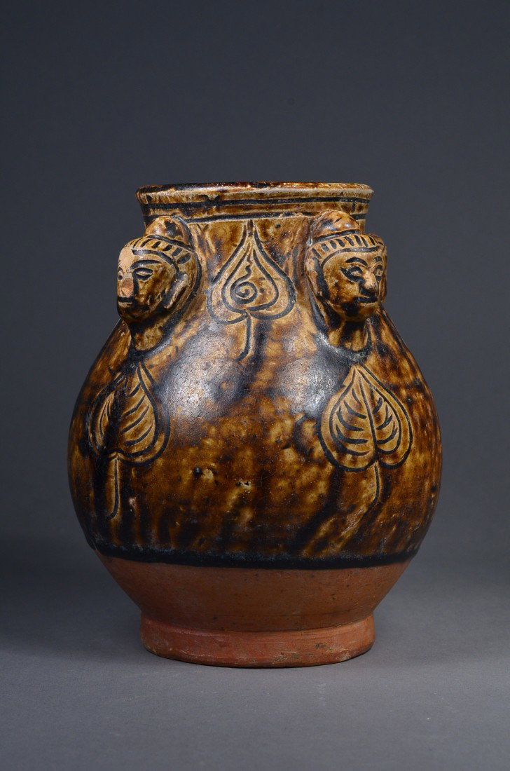 Chinese Qing Brown Glazed Jar w/ Buddha Heads: Chinese Qing Dynasty brown glazed porcelain vase; bulbous body featuring carved leaf design; underneath flared rim decorated with four Buddha heads; base unglazed; H: 16 cm, D: 12 cm; Toronto Estate C