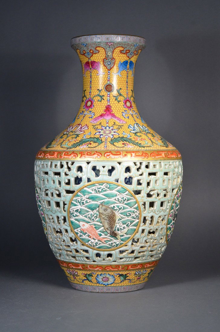 Qing Period Reticulated Vase with Carp Qianlong: Chinese Qing Period porcelain vase; reticulated design, with an inset medallion depicting auspicious waves in front of crashing waves; above and below the geometric dragon band features foreign lotus 
