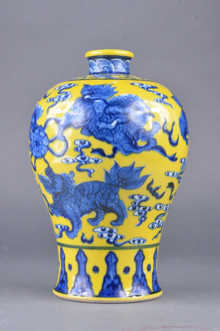Chinese Yellow & Blue Glazed Meiping Vase: Chinese yellow glazed porcelain Meiping vase; tapering body featuring fu lion amid stylized ruyi-head cloud scrolls; Buddhist emblems and wu fu bats on shoulder in blue enameling; short waisted neck f