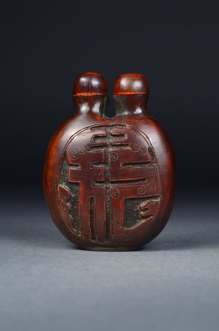 Chinese Horn Carved Dragon Snuff Bottle: Chinese horn carved double mouth snuff bottle; featuring geometric-shaped dragons forming dragon symbol; the stone of rich deep auburn tone; H: 8 cm, W: 6 cm
