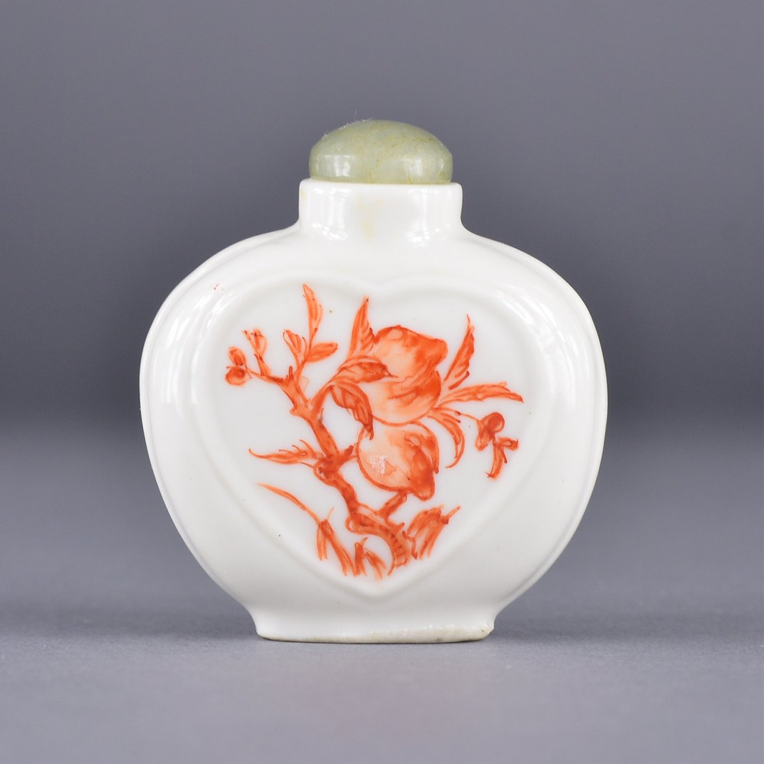 19th Century Chinese Copper Red Snuff Bottle: 19th Century Chinese copper red glazed porcelain snuff bottle; ovoid body featuring peaches and bats, wu fu design; H: 6 cm W: 5 cm, 44 grams