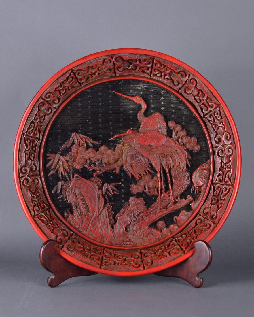 Chinese Cinnabar Lacquer Carved Plate: Chinese cinnabar lacquer carved plate; featuring cranes standing on rockery in relief; D: 30 cm, 777 grams