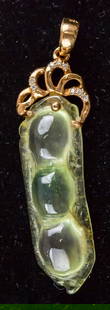Chinese Icy Green Pea Pod 18k Gold Bail: Chinese pendant of light green tone. Carved into the shape of pea pod with 18K stamp on bail. 4 x 1 cm. 4 grams.