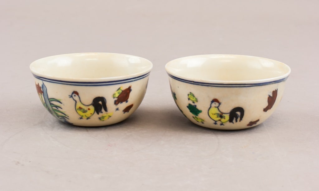 Pair of Chinese Chicken Cups w/ Ming Chenghua mark: Pair of Chinese chicken cups. Decorated with chicken and flowers. Ming Chenghua mark on base. 124 grams (2 pcs) H: 3 cm, Diameter: 8 cm