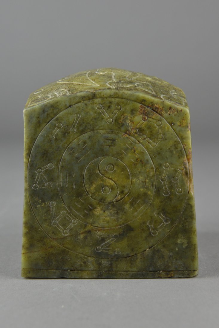 Chinese Qing Period Carved Jade Seal: Chinese Qing Period carved jade seal; square cross-section; featuring incised Buddhist designs in relief; four-character seal chop on base; the stone of translucent green tone with yellow suffusions; 