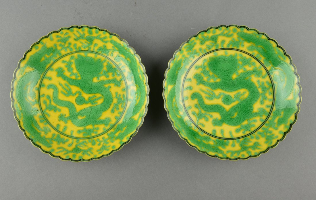 Pair Chinese Yellow Ground Foliate Plates Qianlong: Pair of Chinese imperial yellow ground foliate-shaped plates; featuring writhing dragons in green enameling; six-character Qianlong Mark; D: 14 cm, H: 3 cm (each)