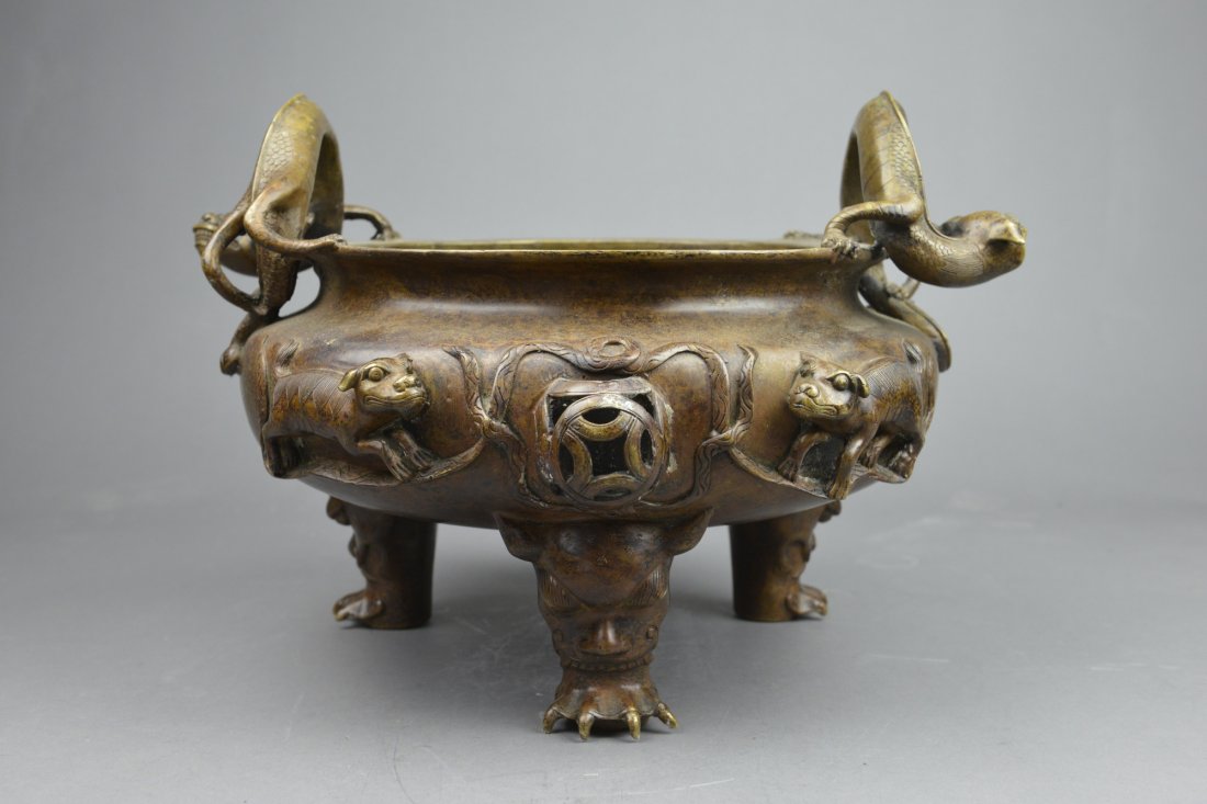 Large Chinese Ming Marked Bronze Tripod Censer: Very Large Chinese Ming marked bronze tripod censer; ovoid body featuring a pair of molded cast antithetical mythical beasts beside openwork puzzle ball knob; handles in form of chilong; supported on 
