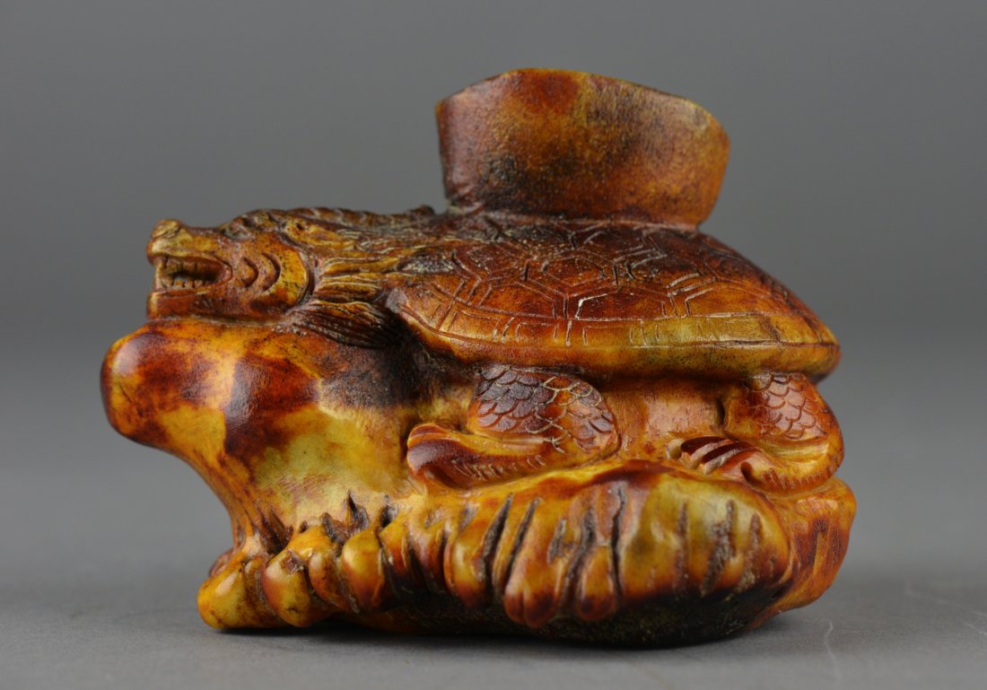 Chinese Horn Carved Figure of Turtle Dragon: Chinese horn carved figure; featuring turtle atop rockery with an alms bowl on his shell; L: 11 cm, W: 8 cm, H: 8.25 cm, 366 grams It is the responsibility of the buyer to obtain CITES export permits.