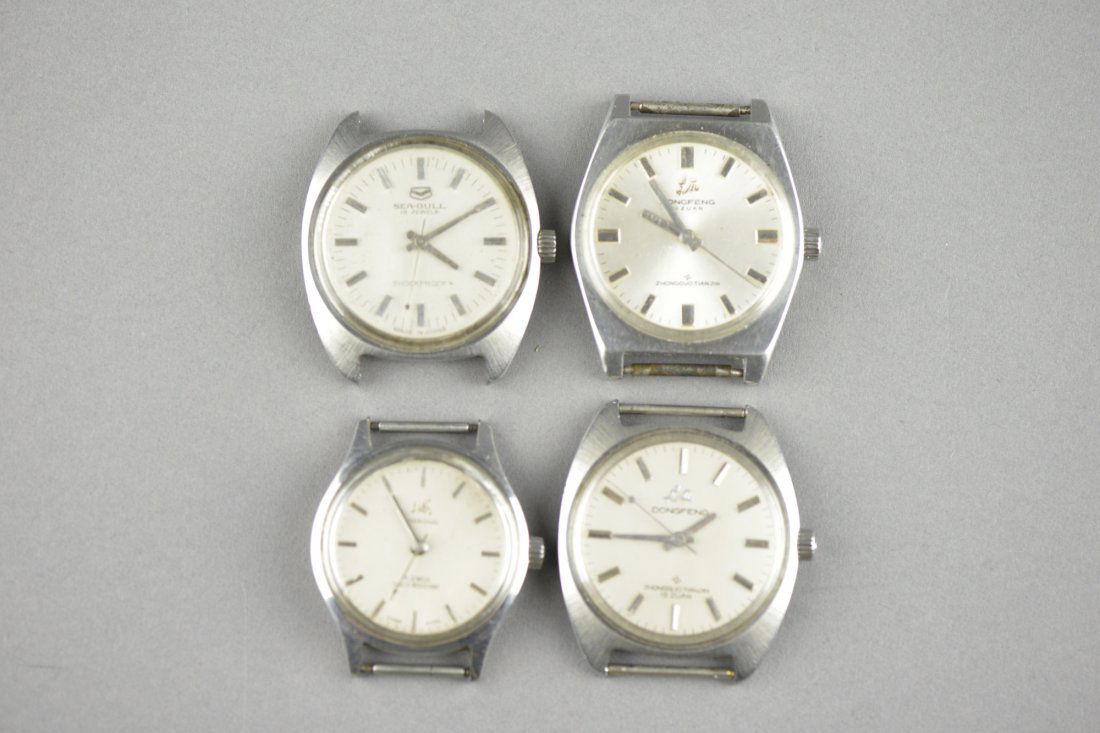 Set of Four Vintage Chinese-Made Dongfeng Watches: Antique set of four genuine vintage Chinese Dongfeng watches; marked "ST5-H6 DONGFENG" and "Shanghai Watch Factory ZSH"; L: 4 cm, W:3 cm, 35 grams
