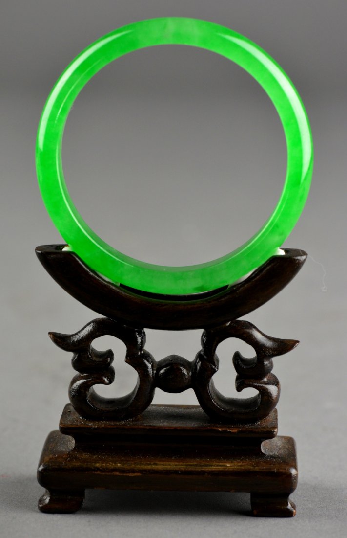 Set of Two Chinese Carved Jade Bangles: Set of two Chinese carved jade bangles; the stone of translucent green and dark green tone; D: 7.25 cm, 37 grams (green bangle); D: 7.5 cm, 50 grams (dark green bangle)