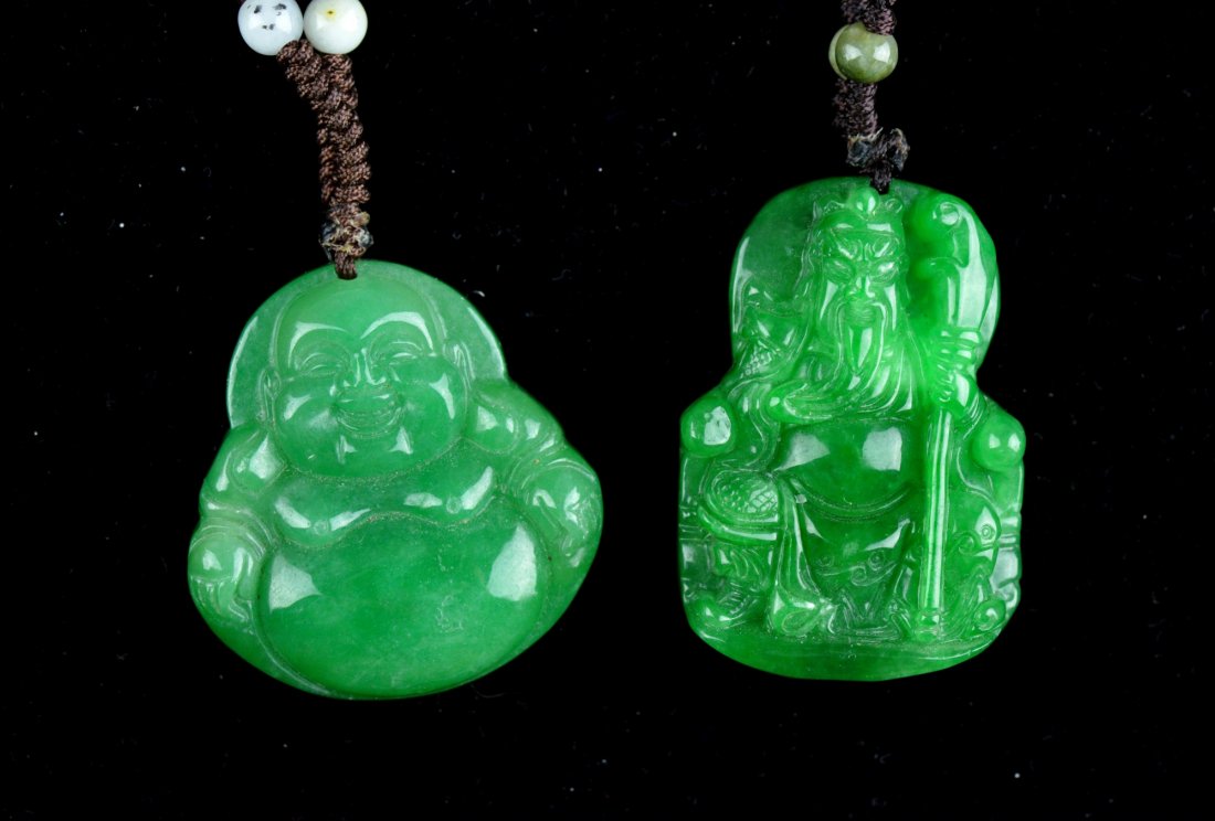 Set of Two Chinese Carved Green Jade Pendants: Set of two Chinese carved jade pendants; one of Laughing Budai and the other featuring General Guan Gong; the stone of translucent green tone; L: 4 cm, 68 grams (Budai pendant); L: 5 cm, 68 grams (Gua
