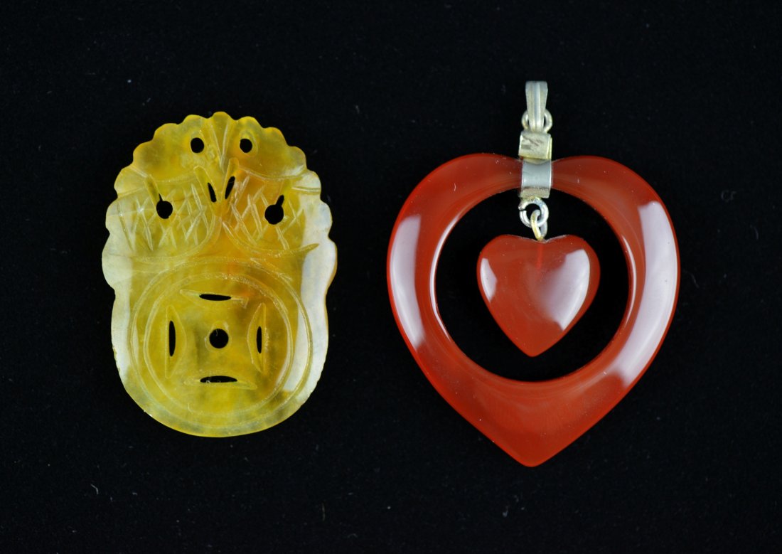 Set Two Chinese Carved Yellow & Red Jade Pendants: Set of two Chinese carved jade pendants; featuring jade pedant in form of heart and the other featuring tong bao with dragon; the stone of translucent red and yellow tone; L: 4.5 cm, 8 grams (red pend