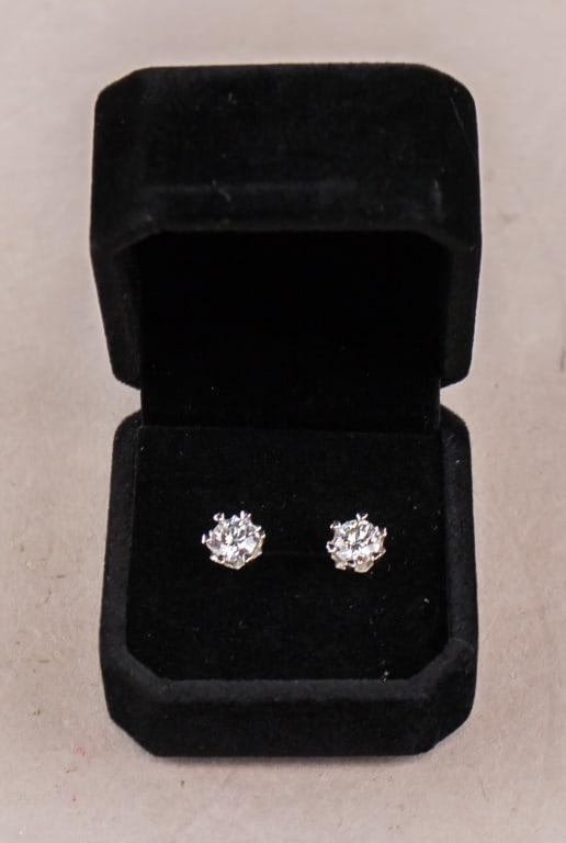 White Gold Earrings w/ 1.0 ct EF VVS1 Moissanite: 925S White gold earrings. Pair of heart prong set round brilliant cut moissanites, measuring 6.5mm, weight of 1.0 CT. Color = EF. Clarity = VVS1, Cut = Excellent. GRA Report Number: 107314862