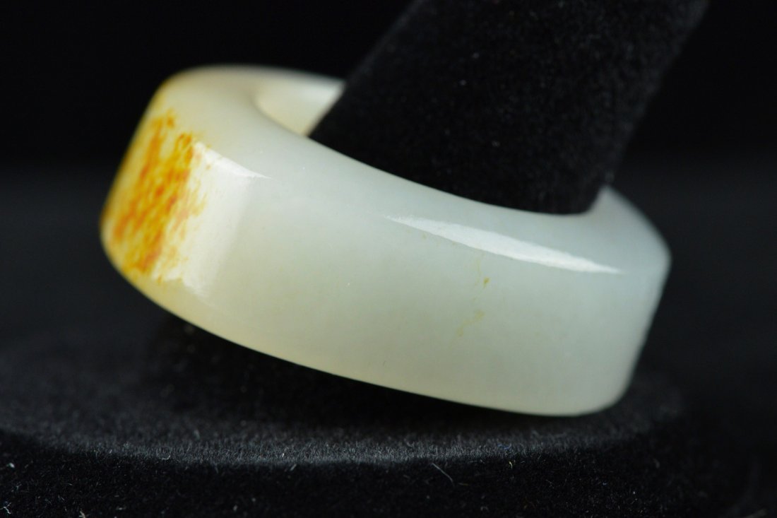 Very Fine Chinese Two Colour Jade Ring: Very fine Chinese two colour jade ring; the stone of translucent white tone with mutton fat suffusions near the top of the ring; D: 3 cm, D: 2 cm (interior diameter); 15 grams