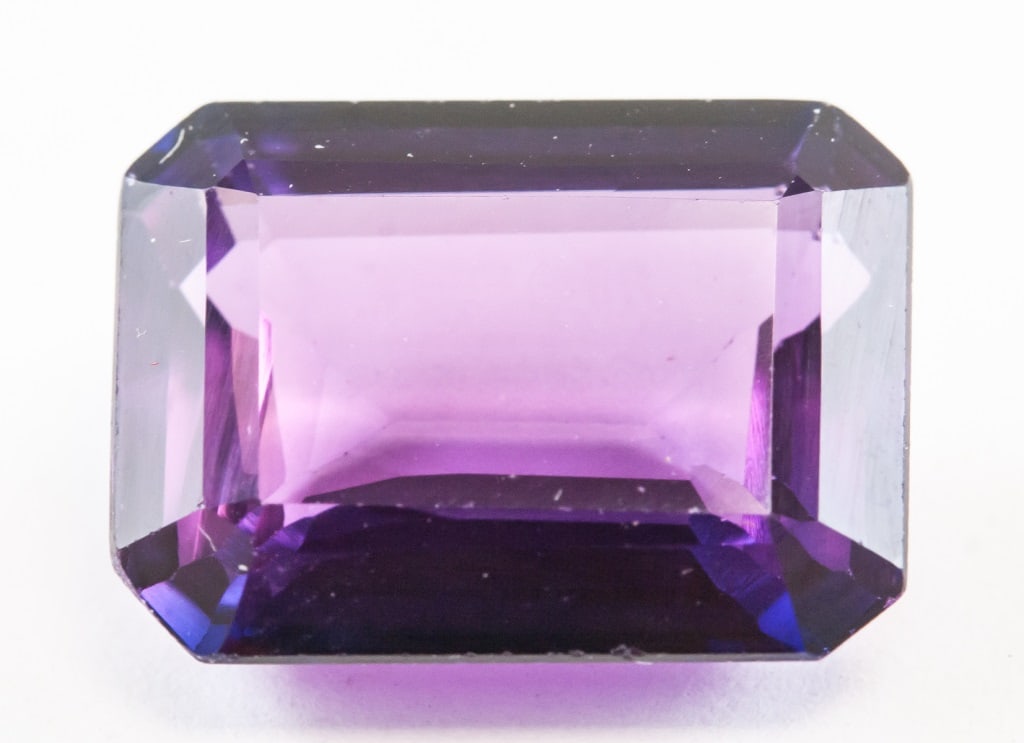 11.40ct Emerald Cut Blue Natural Alexandrite GGL: One (1) 11.40 ct emerald cut blue to purple natural alexandrite. Origin: India. 14.42 x 10.74 x 6.12 mm. Accompanied with GGL certificate.
