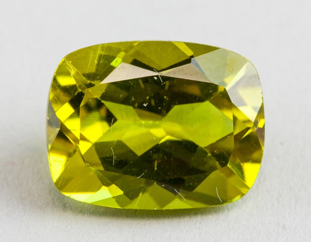 5.70ct Cushion Cut Natural Alexandrite GGL: One (1) 5.70 ct cushion cut yellow to greenish alexandrite gemstone. 12.09 x 9.22 x 6.18 mm. Accompanied with GGL certificate.