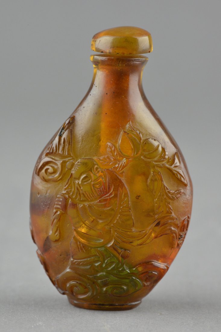 Chinese Carved Amber Snuff Bottle 19th Century: Chinese carved amber snuff bottle with cap, 19th century; carved figure of old man; the tone of light apricot; H: 7, D: 4