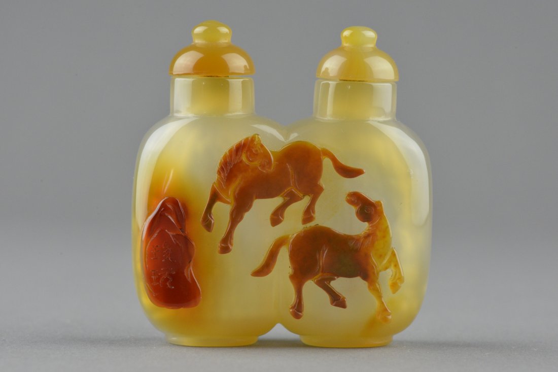 Chinese Smoky Agate Carved Horse Twin Snuff Bottle: Chinese carved agate twin snuff bottle with cap; featuring horses in play; the stone of light apricot with caramel suffusions; H 6 cm, W 6 cm, 78 grams ; Provenance: T. Ng Collection Toronto