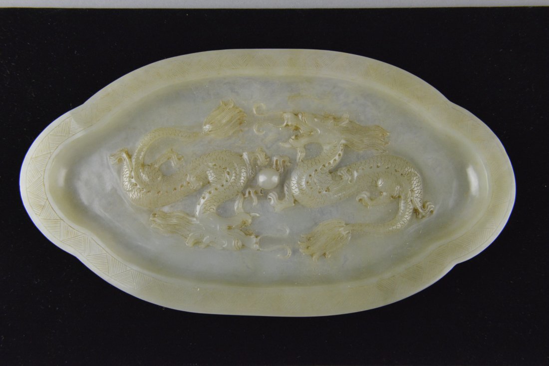 Fine Chinese Qianlong White Jade Dragon Plate: Very fine Chinese carved jade plate; shallow plate featuring pair of dragons chasing flaming pearl in relief; the stone of light translucent celadon tone with very slight mutton fat suffusions; four-c