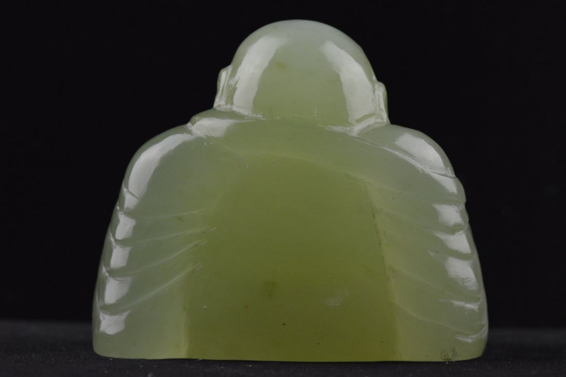 Chinese Carved Celadon Jade Figure Laughing Budai: Chinese carved jade figure; featuring Laughing Budai seated and holding onto prayer beads and typical cloth sack; L: 8cm, W: 4.25 cm, H: 5.5 cm, 296 grams. Provenance: Eastern Shen Collection, Toronto