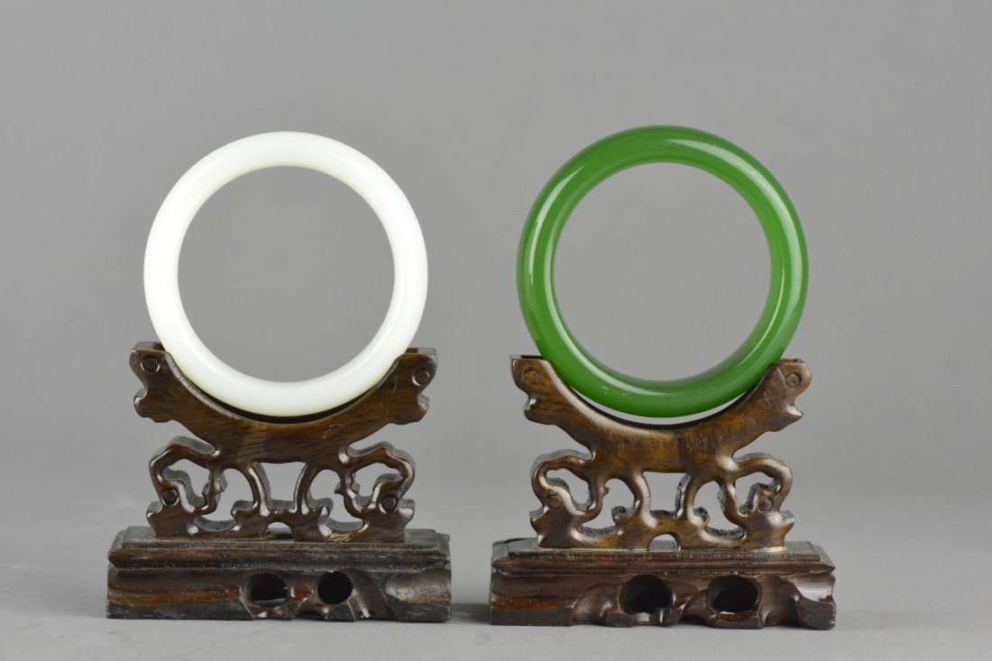 Set of two Chinese Carved Jade Bangles: Set of two Chinese carved jade bangles; the stone of spinach green and white tone; Inner 75 grams, D:5.5; Inner; D:5.5, 64 grams