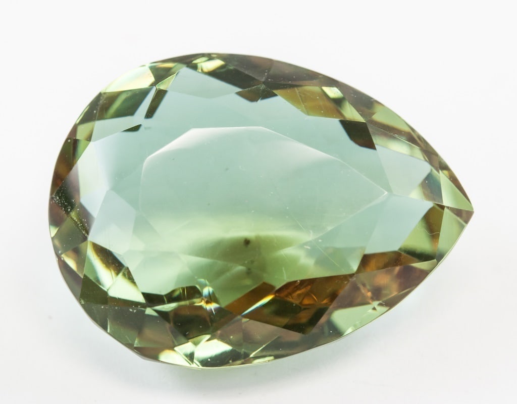 76.95ct Pear Cut Brown to Green Alexandrite GGL: One (1) 76.95 ct pear cut brown to green Alexandrite. Origin: Brazil. Accompanied with a GGL certificate. 32.14 x x 24.49 x 15.47 mm
