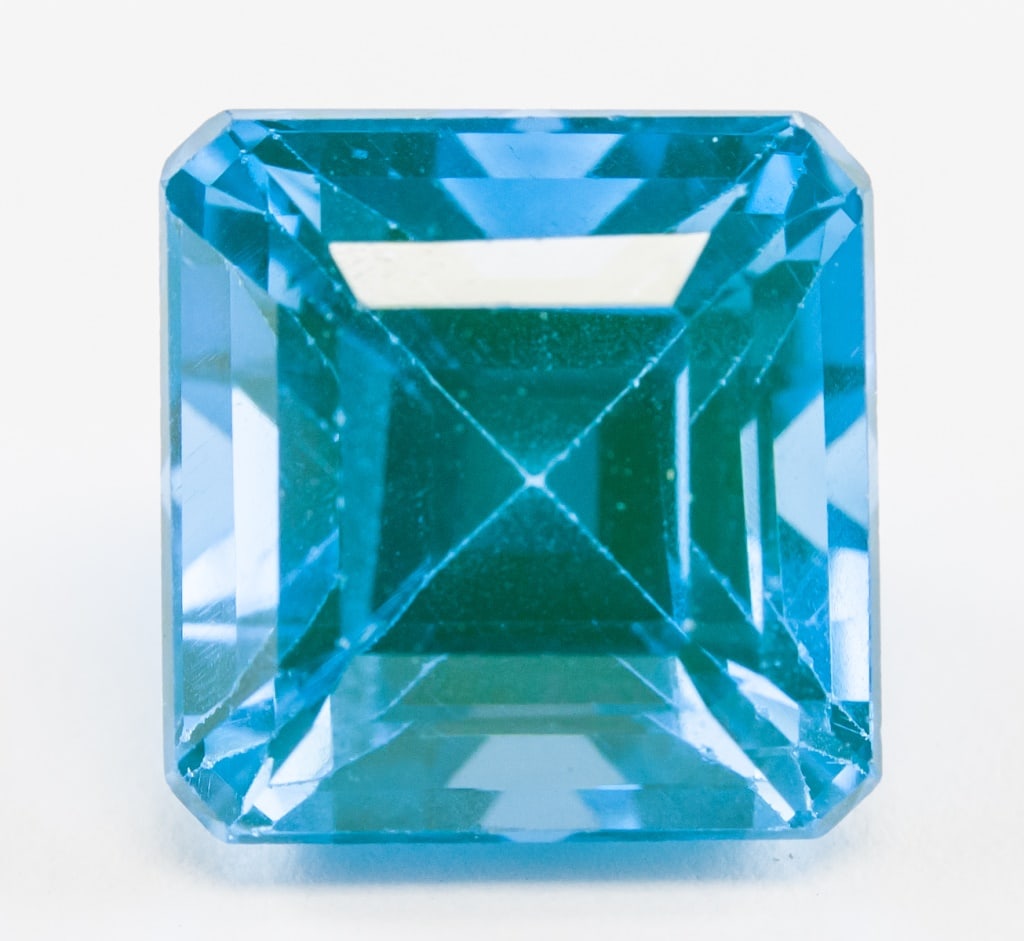 6.95ct Emerald Cut Natural Grandidierite GGL: One (1) 6.95 ct emerald cut bluish green natural Grandidierite. 9.77 x 9.44 x 8.12 mm. Accompanied with GGL certificate.