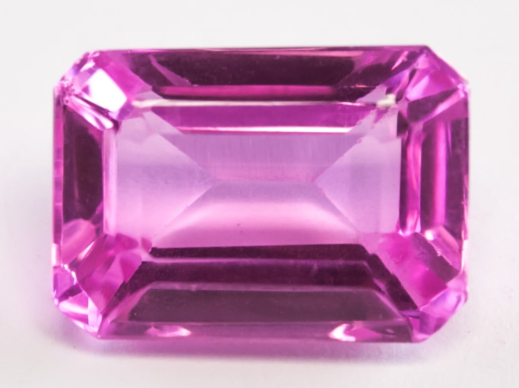 10.00ct Emerald Cut Natural Montana Sapphire GGL: 10.00 ct emerald cut pink natural montana Sapphire. Origin: USA. Accompanied with GGL certificate. 13.62 x 9.69 x 6.66 mm.