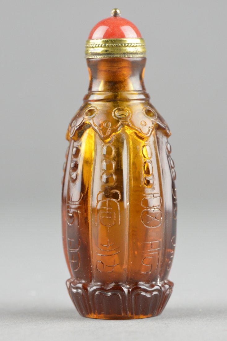 Coral Peking Glass Snuff Bottle Qianlong mark: Chinese carved Peking glass snuff bottle with cap, 18th century of sectioned ovoid form; each section marked Fu and Shao between ruyi bands; four characters Qianlong mark on base; H: 8 cm, 56 grams